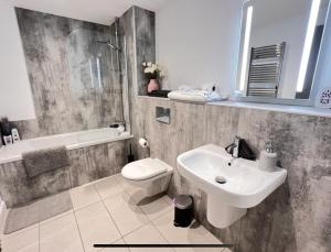 a bathroom with a sink and a toilet at Royal Atlantic View Apartment in Portrush