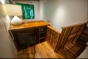 a desk with a lamp and a chair in a room at Condo VNV walking distance to the beach in Nosara +7 photos