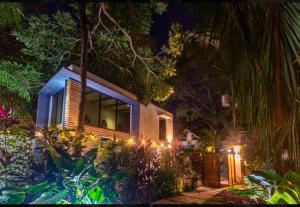 una casa con luces en el jardín por la noche en Condo VNV walking to Playa Guiones, en Nosara