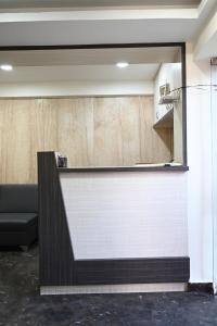 a reception counter in a room with a couch at Supraja Cyber View in Hyderabad