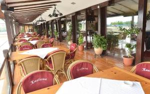 a row of tables and chairs in a restaurant at Motel Kneginja in Čačak