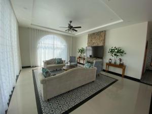 a living room with a couch and a table at Emirate Villa Mui Ne in Mui Ne