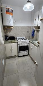 a kitchen with a stove and a counter top at Depto de 2 ambientes zona Guemes (2) in Mar del Plata