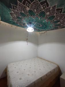 a bedroom with a bed with a painting on the ceiling at SHANTI - HOME MAR AZUL in Mar Azul