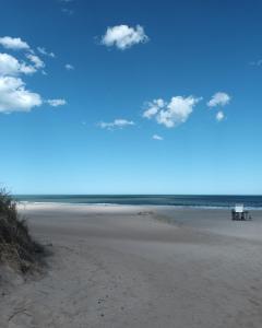 a view of a beach with a bench on it at SHANTI - HOME MAR AZUL in Mar Azul