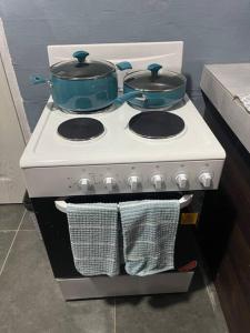 a stove with two pots and pans on top of it at Sale’aula Lava Studio Apartment in Saleaula
