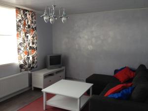 a living room with a couch and a tv at LappeanLohi in Lappea