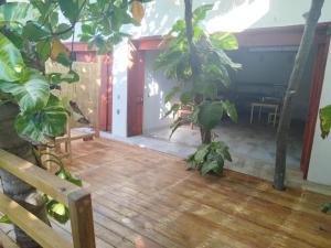 a room with a wooden floor and plants at Bambú Ecocabañas in San Agustinillo