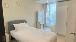 a bedroom with a white bed and a window at Sky Suite Kota Kinabalu-6 Pax-2Rooms-5MinsDrive-Imago,SuteraAve,Riverson,KKTimeSquare in Kota Kinabalu