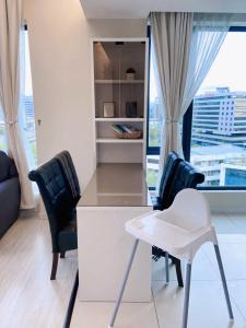 a kitchen with two chairs and a desk with a window at Sky Suite Kota Kinabalu-6 Pax-2Rooms-5MinsDrive-Imago,SuteraAve,Riverson,KKTimeSquare in Kota Kinabalu