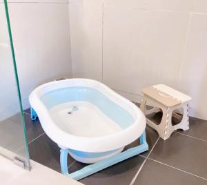 a bath tub in a bathroom with a stool at Sky Suite Kota Kinabalu-6 Pax-2Rooms-5MinsDrive-Imago,SuteraAve,Riverson,KKTimeSquare in Kota Kinabalu