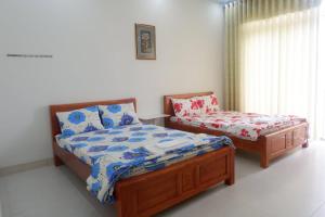 1 dormitorio con 1 cama y 1 silla en Khách sạn Hương Sen Sa Dec, en Sa Ðéc