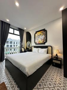 a bedroom with a large bed and a large window at Mộc Lâm Homestay in Phú Quốc