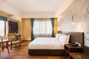 Letto o letti in una camera di Atisha Hotel