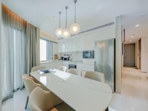 a kitchen and dining room with a white table and chairs at Dubai careek Harbour in Dubai