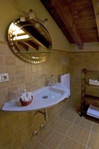 een badkamer met een wastafel en een spiegel bij La Llosa de Repelao in Covadonga