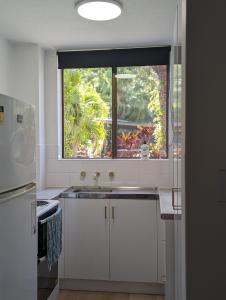 a kitchen with a sink and a window at Dunes Holiday Apartment Unit 8 in Coffs Harbour