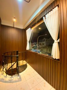 a balcony with a window with a sink in it at SKY Homestay in Ấp Ðại Tài (2)