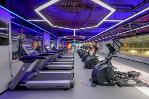 a gym with a row of treadms and machines at Lv Shou Hotel in Shanghai