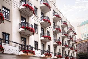 a facade of a building with flowerpots on balconies at The Yangtze Boutique Shanghai - Free minibar for the first round of the day in Shanghai