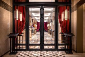 a glass door with red curtains in a store at The Yangtze Boutique Shanghai - Free minibar for the first round of the day in Shanghai