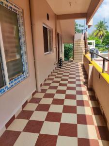 an empty hallway with a checkered floor at luxury home in Vadavalli in Coimbatore