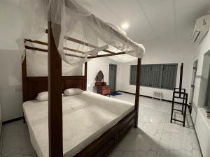 a bedroom with two bunk beds and a ladder at Villa 95 in Dickwella
