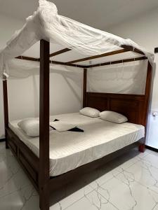 a bedroom with a bunk bed with white sheets at Villa 95 in Dickwella