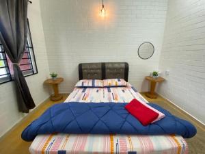 a bedroom with two beds in a room at Brickhouse Parit Raja UTHM in Parit Raja +3 photos