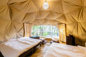 a room with two beds in a tent at glampark Akasawa Onsen Tochigi in Nasushiobara