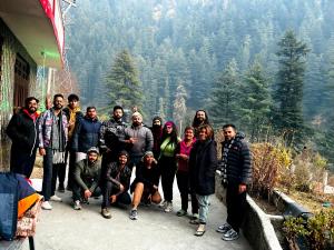 a group of people posing for a picture on a mountain at Snow View Guest House in Kasol