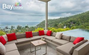 a living room with a couch and a swimming pool at Luxury Asian Flair Villa in Ko Phangan