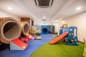 a play room with a slide and a playground at Kokotel Phuket Patong - SHA Extra Plus in Patong Beach