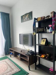 a living room with a desk and a television at Putrajaya Homestay (Zurinn 2) in Putrajaya