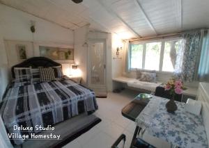 a bedroom with a bed and a window at Village Homestay in Udon Thani