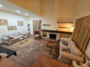 a living room with a couch and a fireplace at Finca Altair in Madrid