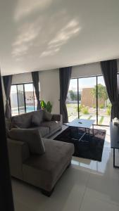 a living room with a couch and a table at The sunset farm in á¸¨aÅŸat al BidÄ«yah