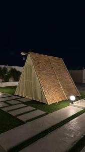 a building with a cover on the side of it at The sunset farm in á¸¨aÅŸat al BidÄ«yah