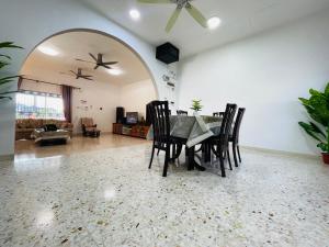 a dining room with a table and chairs at GreenPine Kota Tinggi Homestay in Kota Tinggi