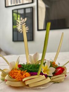 a flower arrangement on a plate on a table at The CIVYT in Ubud