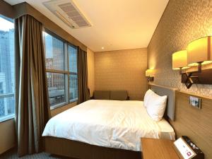 Postel nebo postele na pokoji v ubytování Mohenic Hotel Seoul Myeongdong