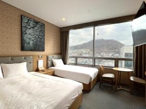 Postel nebo postele na pokoji v ubytování Mohenic Hotel Seoul Myeongdong