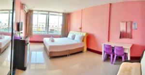 1 dormitorio con 1 cama y 2 sillas moradas en โรงเเรมคิงส์พาเลซ King's Palace HOTEL, en Seka