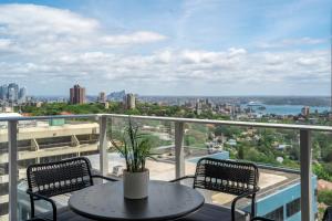 a balcony with a table and two chairs at Spectacular City & Harbour Views: Bondi Junction in Sydney