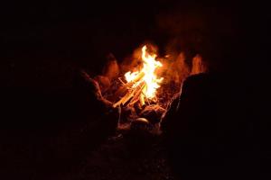 a fire is burning in the dark at Sunny Side Cottage in Shimoda