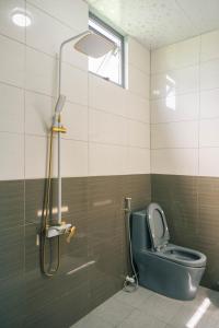 a bathroom with a toilet and a shower at Homestay Bến Tre in Ben Tre