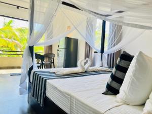 A bed or beds in a room at Tropical Plant Villa - Tangalle