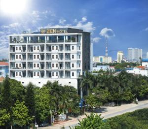 a white hotel with a sign on top of it at ZEN RIVERSIDE HOTEL & RESIDENCES in Hai Phong