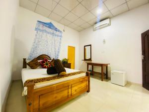 A bed or beds in a room at Priyavimana resort