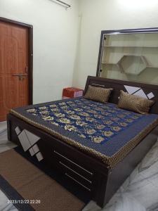 a large bed in a room with a bed frame at Gokulam Villa in Udaipur